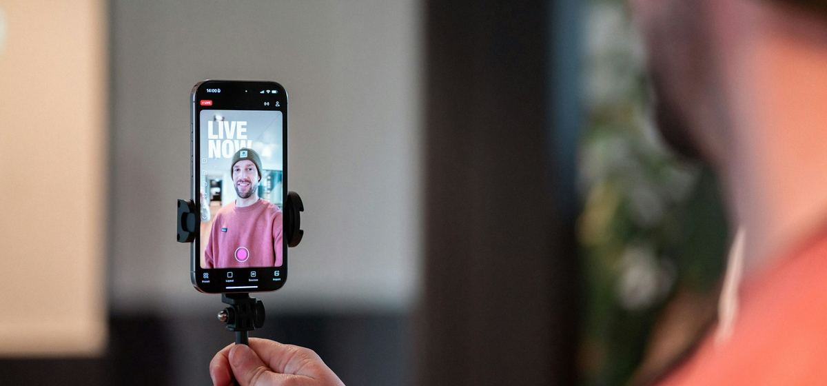 A creator filming a live video on a smartphone